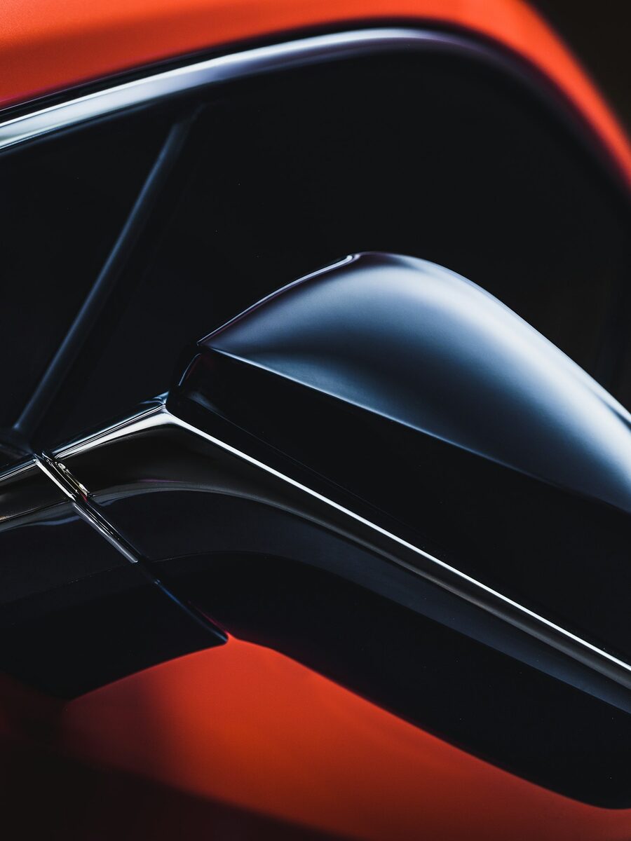 Close-up of a freshly coated glossy black car body panel