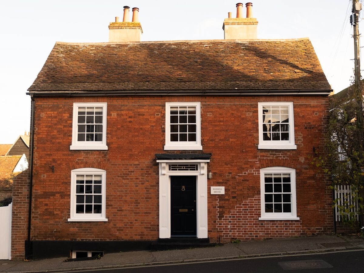 Red brick Georgian townhouse with a black front door