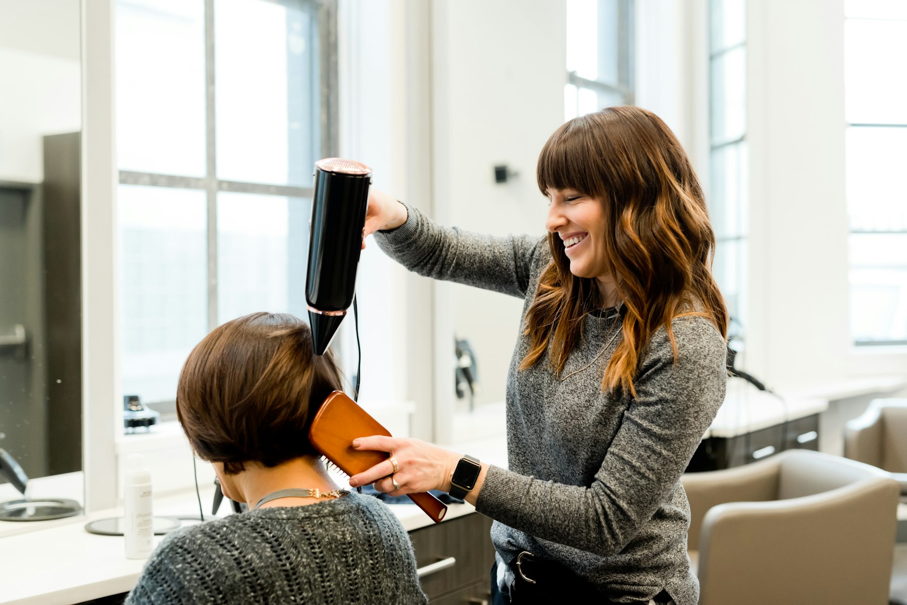 A client in the chair having her hair blow-dried at Shear Luxe