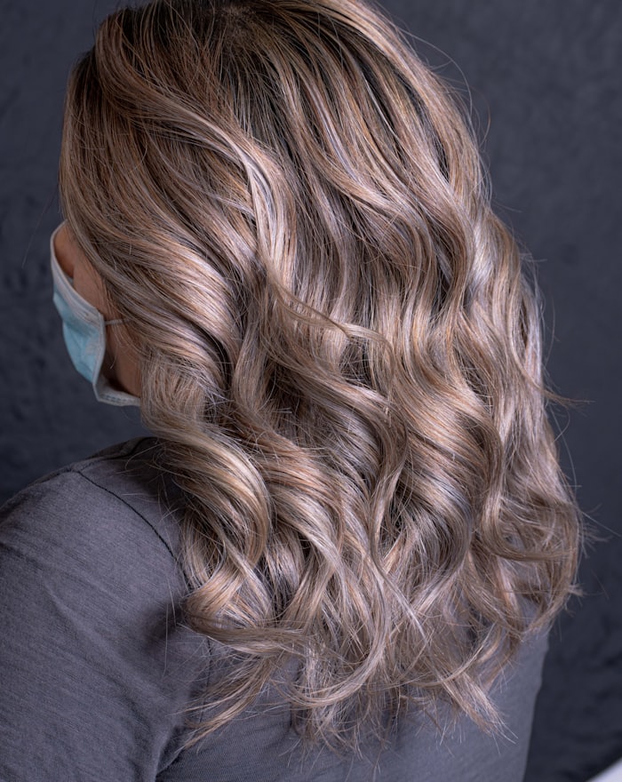Ash blonde curls with a soft root shadow