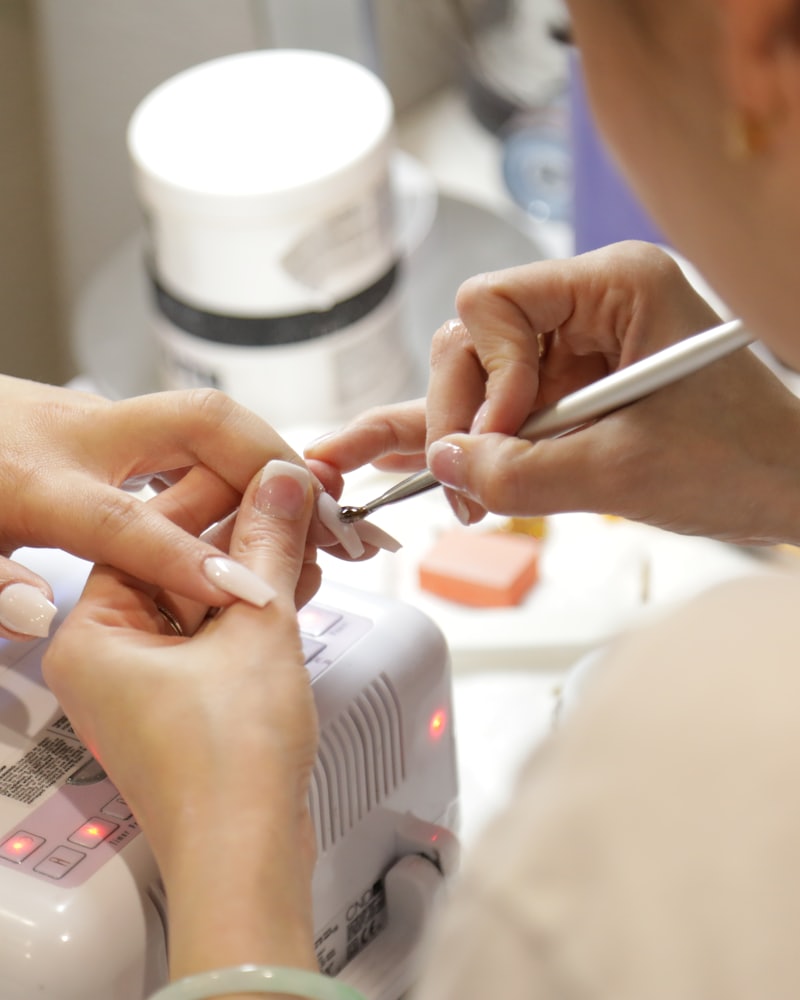 A gel manicure being finished at the nail bar